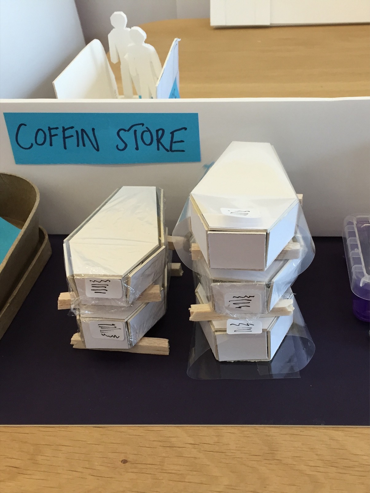 Small cardboard model of the coffin store